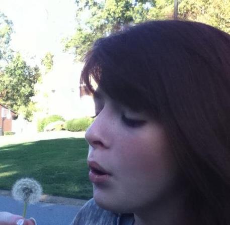 Me blowing a dandelion